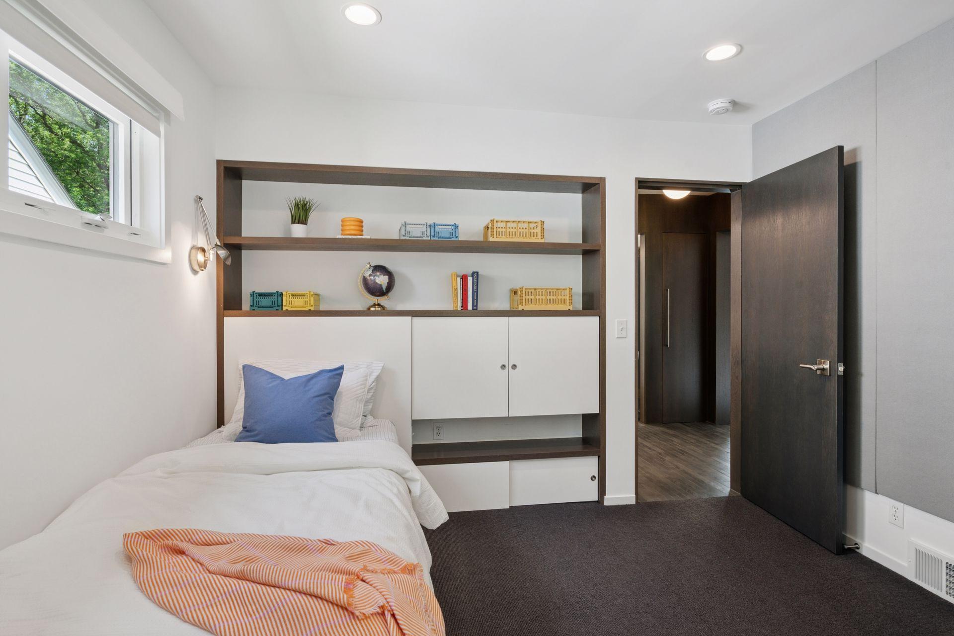 One of two guest/kids bedrooms with custom built-in cabinetry