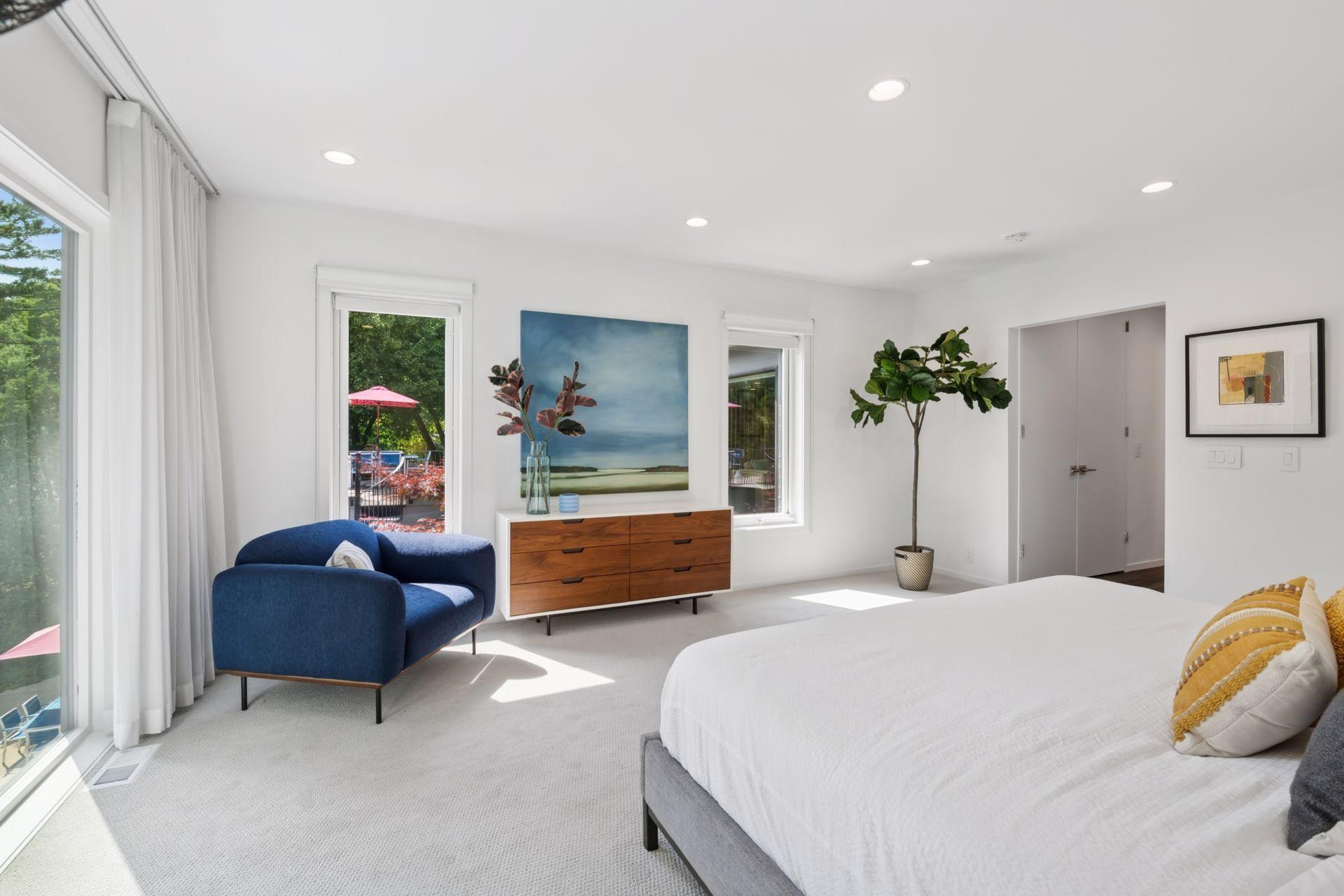 Primary suite with large glass facing Minnehaha Creek and the pool