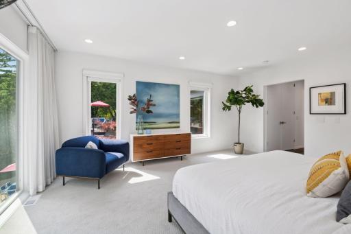 Primary suite with large glass facing Minnehaha Creek and the pool