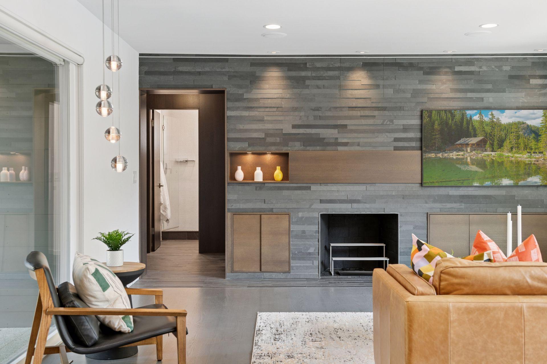 Main level living room with wood burning fireplace and slate tile wall and Frame TV