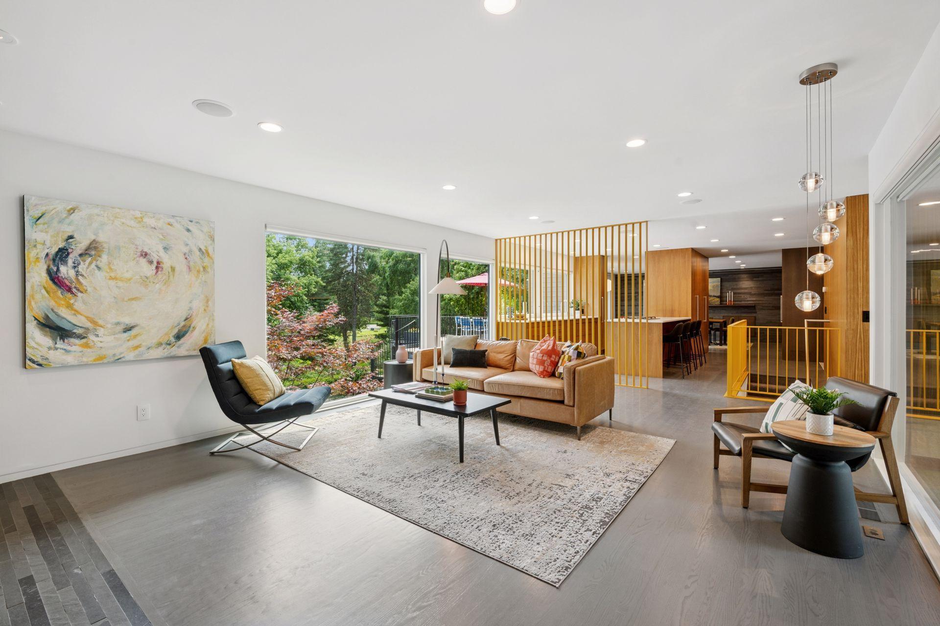Open floor plan with living room, kitchen, and dining room featuring mid-century modern finishes