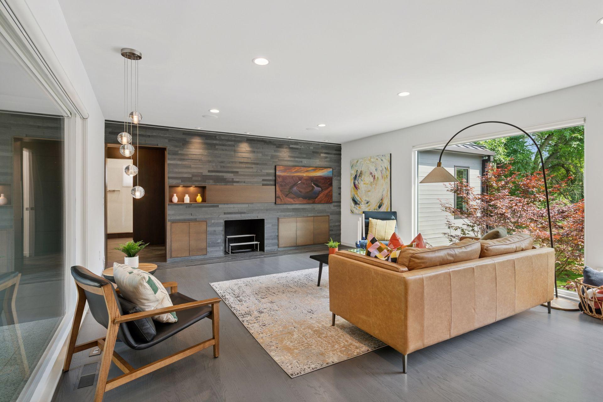 Main level living room with wood burning fireplace and slate tile wall and Frame TV
