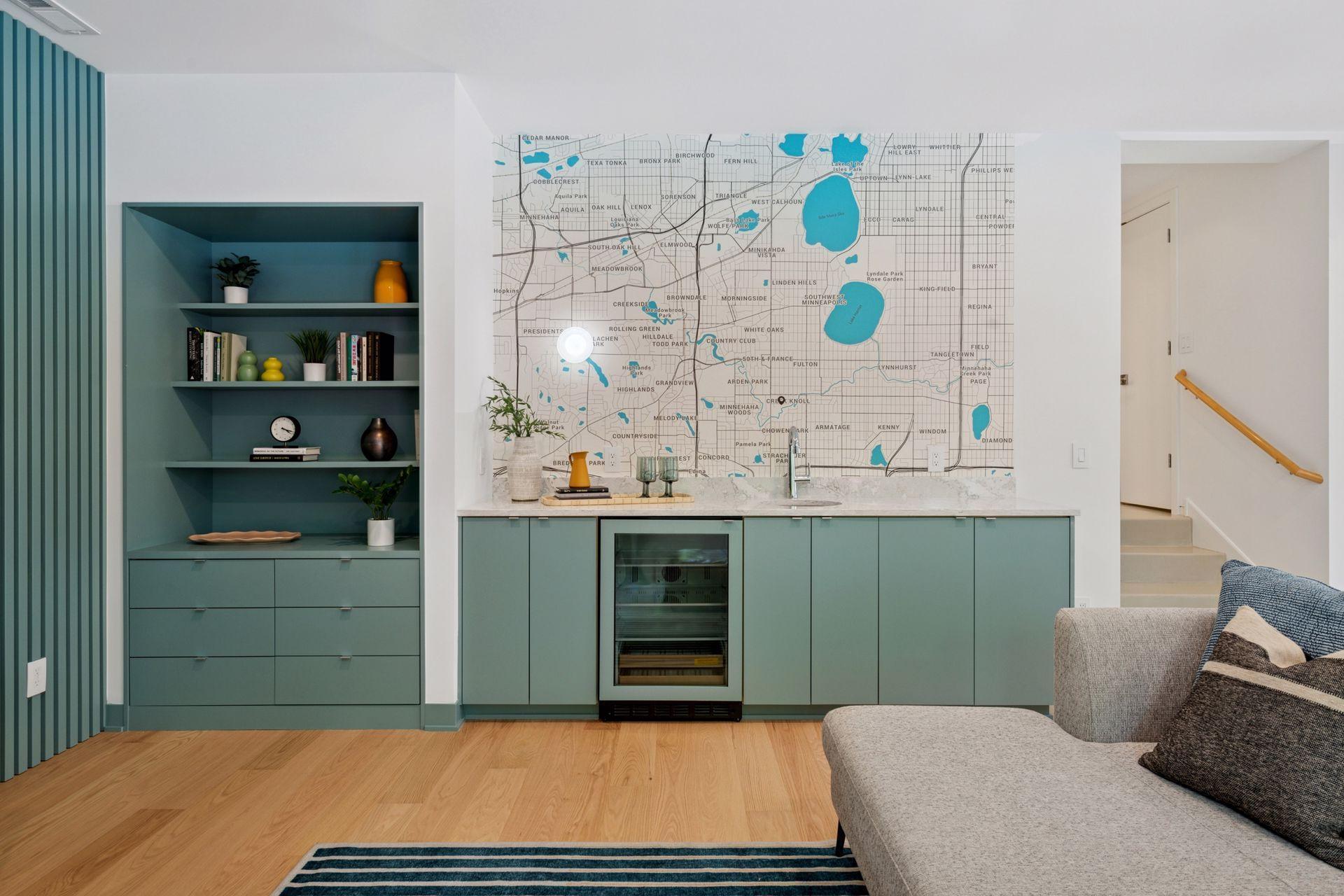 New lower level sunken family room and wet bar with sink, beverage fridge, storage cabinet, and custom wallpaper