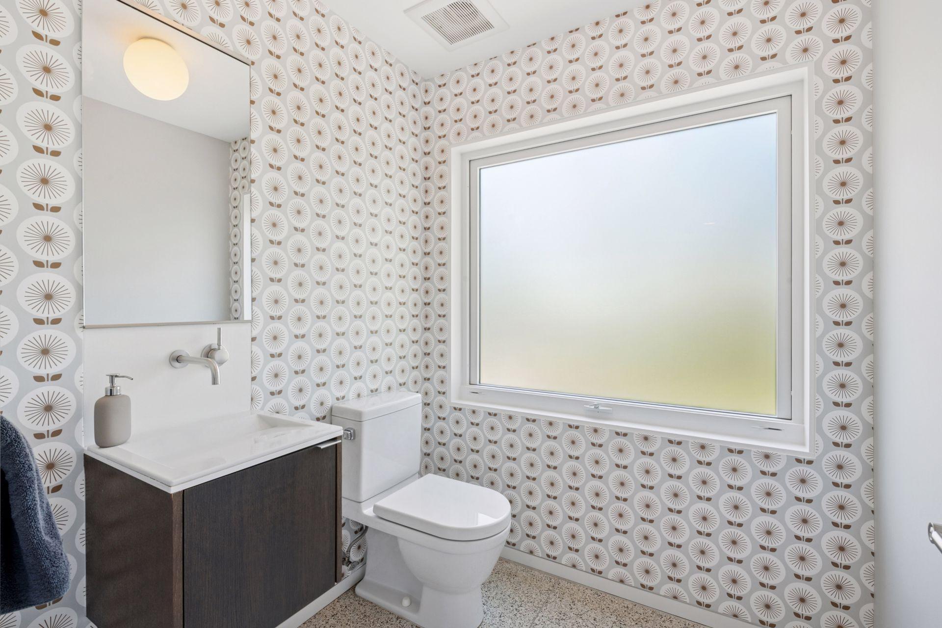 Main level half bath with custom wallpaper