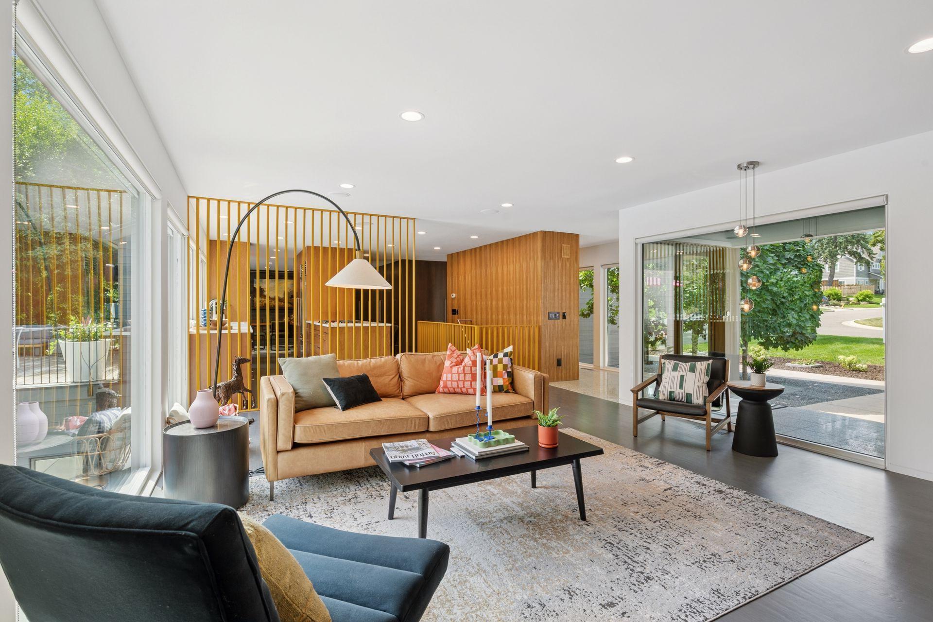 Main level living room with easy access to the open kitchen and foyer/mudroom