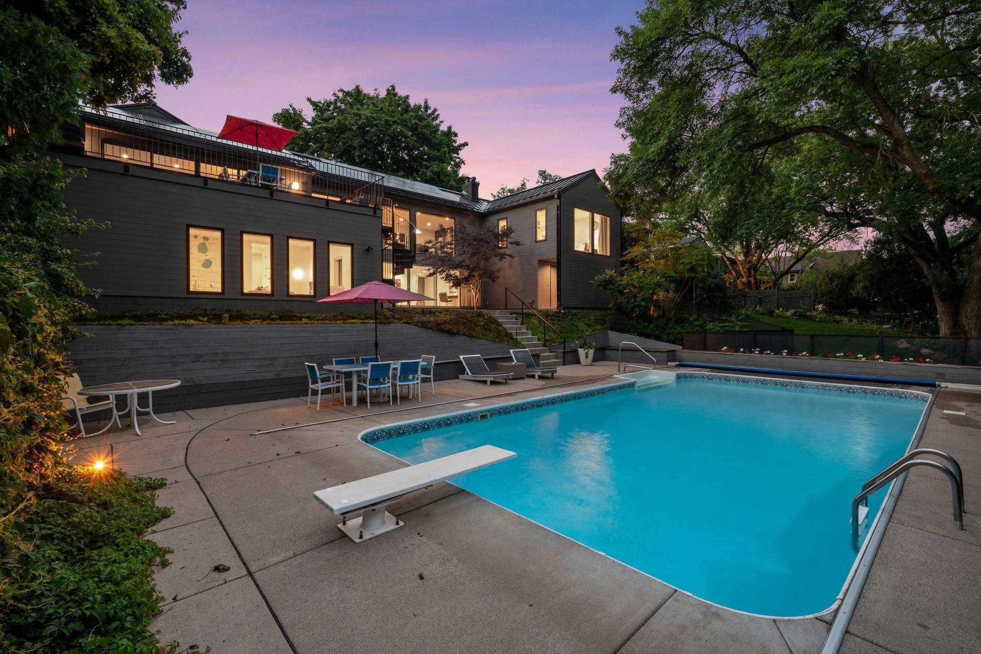Large pool, patios, and wooded views