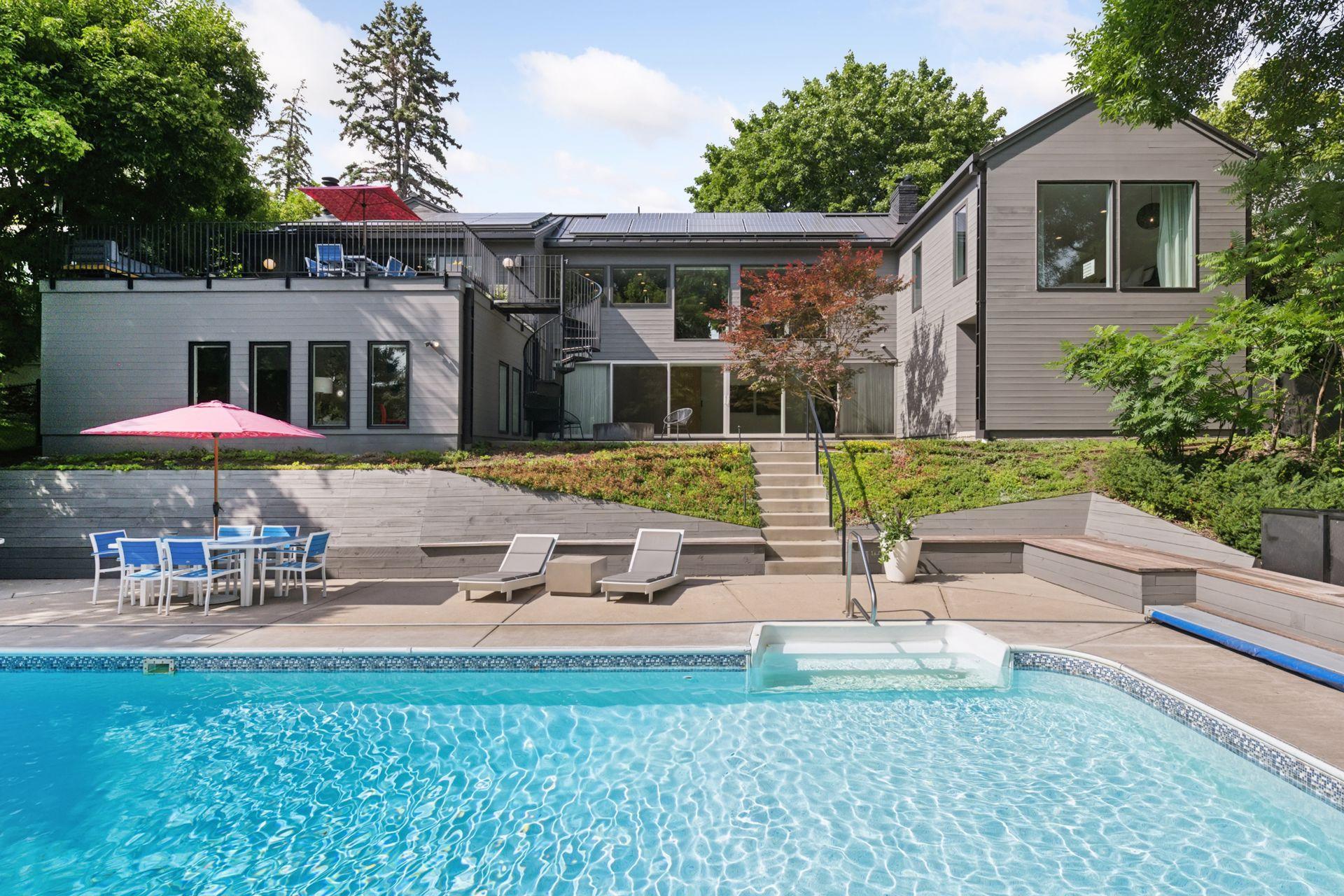 Pool, patios, solar panels, luscious landscaping, and new siding/gutters