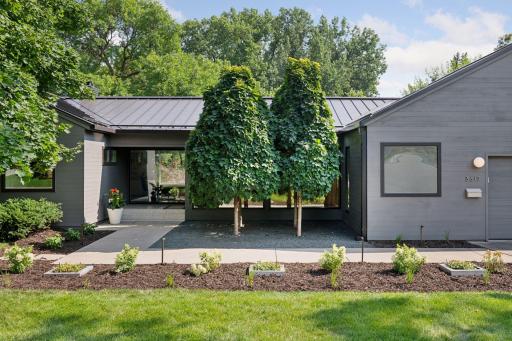 Mid-century modern rambler with a standing seam metal roof & stunning landscaping