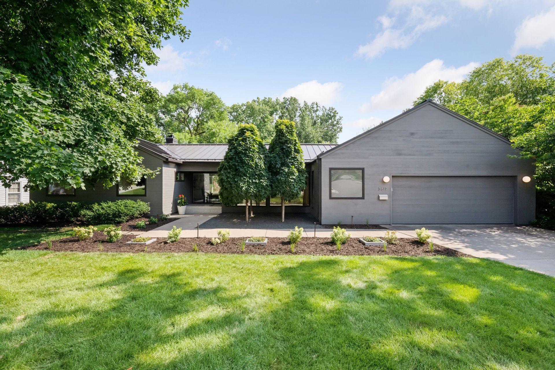 Mid-century modern rambler with a standing seam metal roof & stunning landscaping