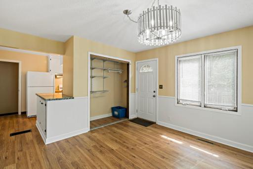 Coat closet is convenient to the back door but also functions as a secondary storage option for kitchen essentials.