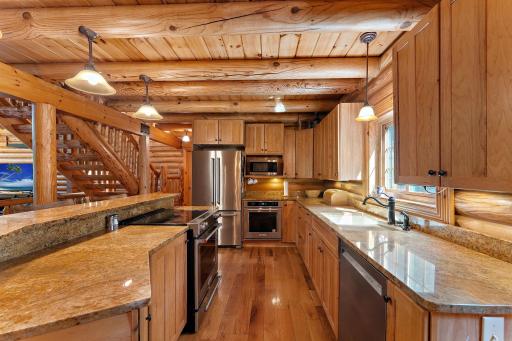 Kitchen is ready for entertaining! Large island, two ovens, plenty of storage in the hickory cabinets and granite counters for all your food prep! Pantry closet is just off the kitchen.