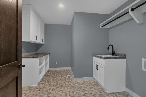 Conveniently located laundry in the upper provides for thoughtful built-ins and laundry sink