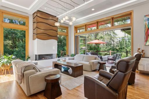 This room is a showstopper and part of the 2021 award-winning design with a custom walnut fireplace upper surround and Dekton surround in the lower with two integrated benches. Transom windows provide additional spectacular natural lighting.