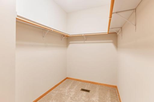 Spacious walk-in closet provides ample storage and organization within the primary suite.