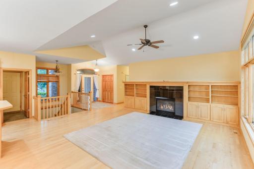 Spacious living area with vaulted ceilings, a ceiling fan, and an open floor concept perfect for comfortable living and entertaining.