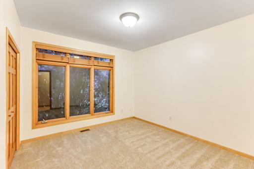 Main floor second bedroom faces the front of the home and features brand new carpet for a fresh, comfortable feel.