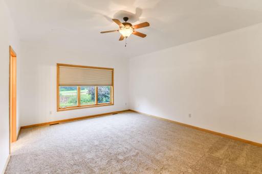 Private primary suite offers a spacious retreat with a large window, walk-in closet, and its own en-suite bathroom for added comfort and convenience.
