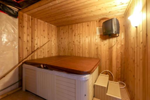 Hot tub is currently inoperable; its electric line was repurposed for an electric stove on the main level. The original gas line remains, and power can be restored to the hot tub if desired.