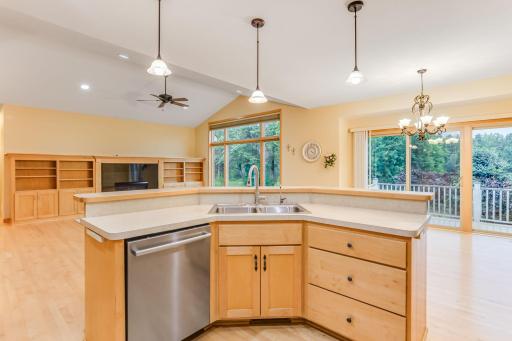 The view from the center island showcases the open main level floor plan, highlighting the seamless flow between kitchen, dining, and living areas.