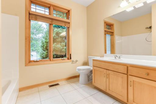 Main floor full bathroom features stylish tiled floors for a clean, durable, and polished look.