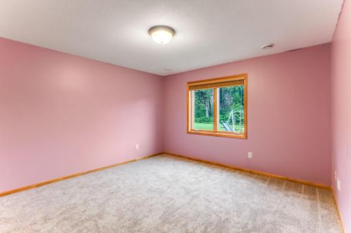 The expansive lower-level bedroom provides ample space for comfort.
