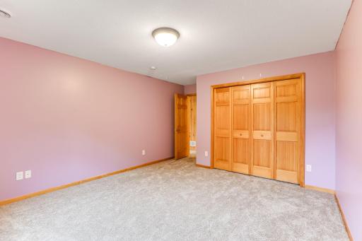 Lower-level bedroom features classic six-panel doors and brand new carpet for a fresh, updated feel.