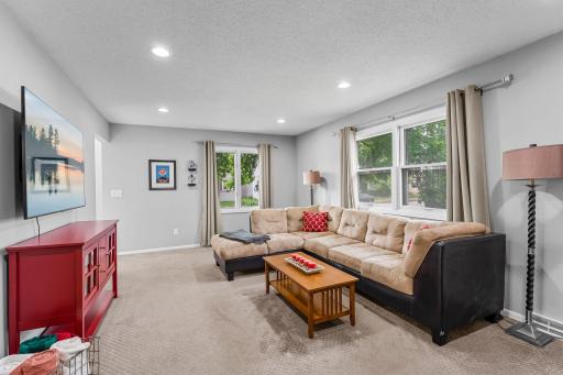 Living room with windows on two walls - lots of natural light.