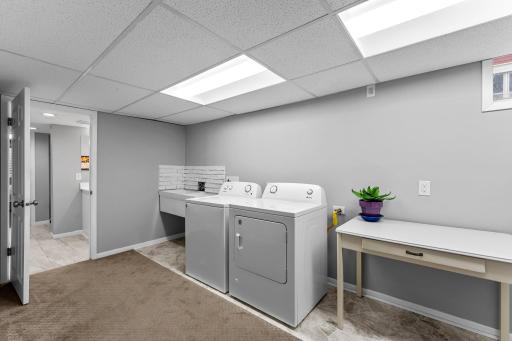 Spacious laundry room with utility room and a storage closet.