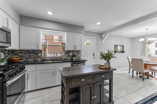 Photo for 607 Adams Street NE, Minneapolis, MN 55413 - listing #6753007 Updated kitchen with granite, stainless and pretty backsplash.