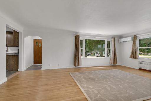 Warm natural light fills the space, highlighting the craftsmanship and architectural details of the era. A perfect blend of vintage charm and inviting comfort.