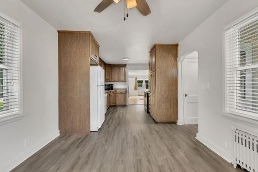 This charming 1940s dining area beautifully blends vintage character with modern updates. Featuring fresh paint, stylish updated light fixtures, and durable LVP flooring.