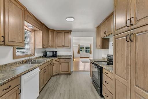 This newly updated kitchen shines with custom cabinetry, sleek new LVP flooring, fresh paint, and modern light fixtures.