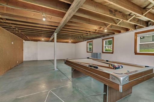 Another view of the unfinished area. Pool table will stay with the property. There once was a shuffleboard court right here. What would you use this space for?