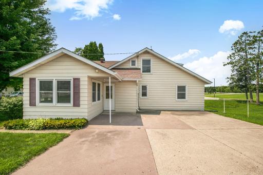 Spacious outdoor concrete patio offers the perfect setting for entertaining or relaxing, featuring durable construction and built-in floor drains for easy maintenance and water management.