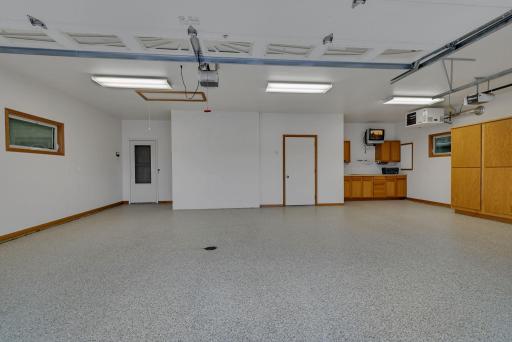 Fully finished garage complete with epoxy floors, heat, shelving and safe room!