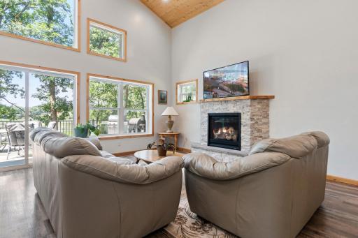 The living room is centered around a cozy gas fireplace.