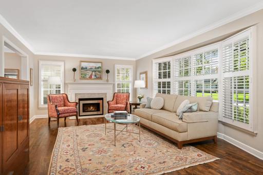 Gorgeous living room with bay window and classic gas fireplace
