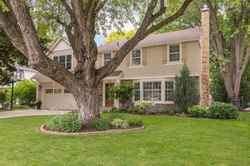 Tremendous curb appeal with a bay window, wood siding, dormer and shutters