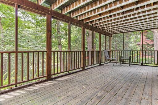 Lower level screened in porch, with access to backyard