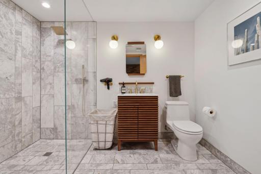 Lower level bathroom with all new finishes, heated marble floors, large zero clearance shower