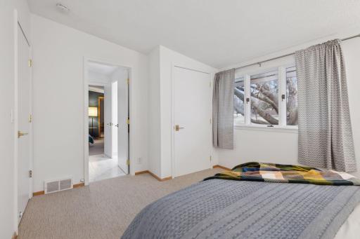 Second main floor bedroom with new carpet looking into bathroom