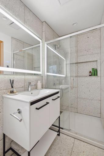 Primary bath completely refinished with heated Terrazzo floors, steam free lighted mirror, bidet toilet