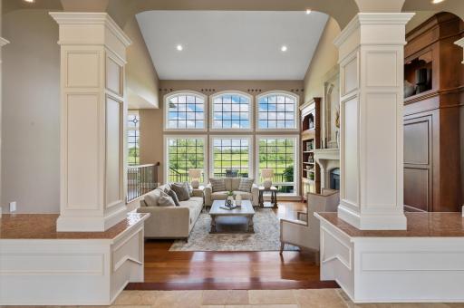 Breathtaking golf course views flood the living room through its expansive windows.