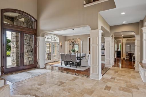 The grand foyer flows seamlessly into the formal dining room.
