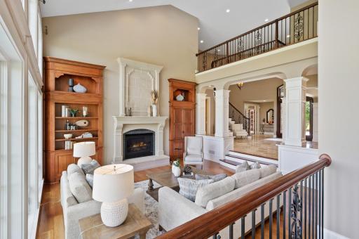 The spacious and inviting living room is the heart of the home with elegant fireplace and open design.