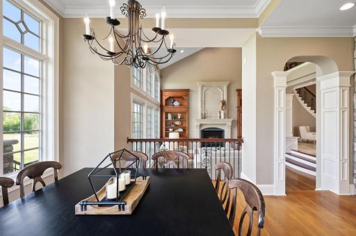 Charming informal dining area with bright windows, looking out onto the expansive living room.