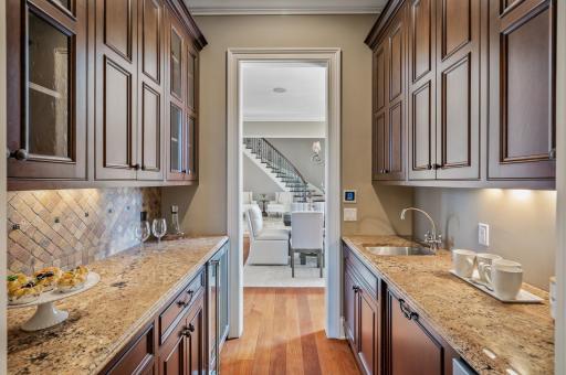 Perfect for hosting, this butler's pantry offers a convenient transition point between the kitchen and dining spaces.