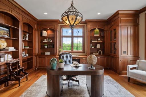 A stylish and professional ambiance defines this beautifully wood-paneled office.