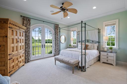 This main-level primary suite boasts French doors leading to the outdoors, creating a peaceful retreat and offering a choice alongside a second primary suite on the upper level.