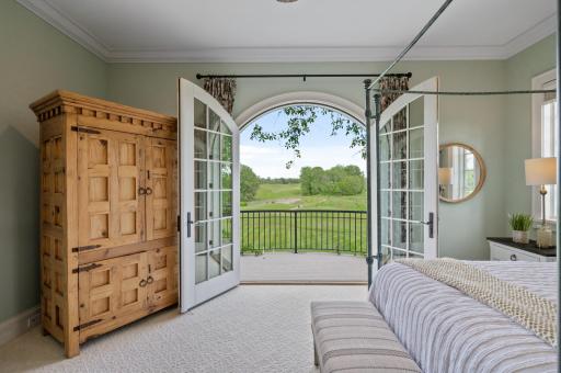 Immerse yourself in the beauty of the surroundings from the comfort of the main-level primary suite, offering direct access to the golf course views.